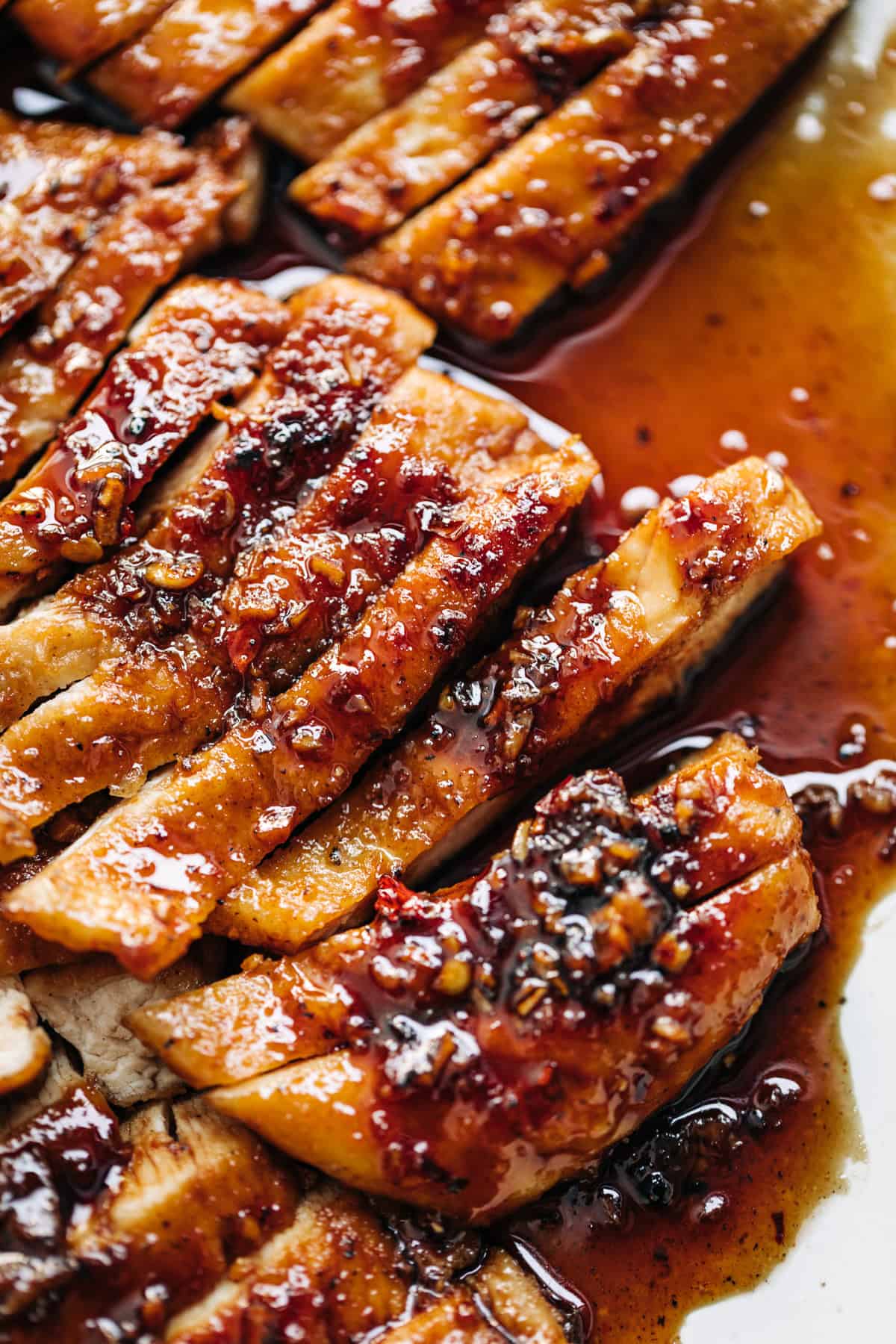 Hot honey butter sauce coating sliced chicken breast.