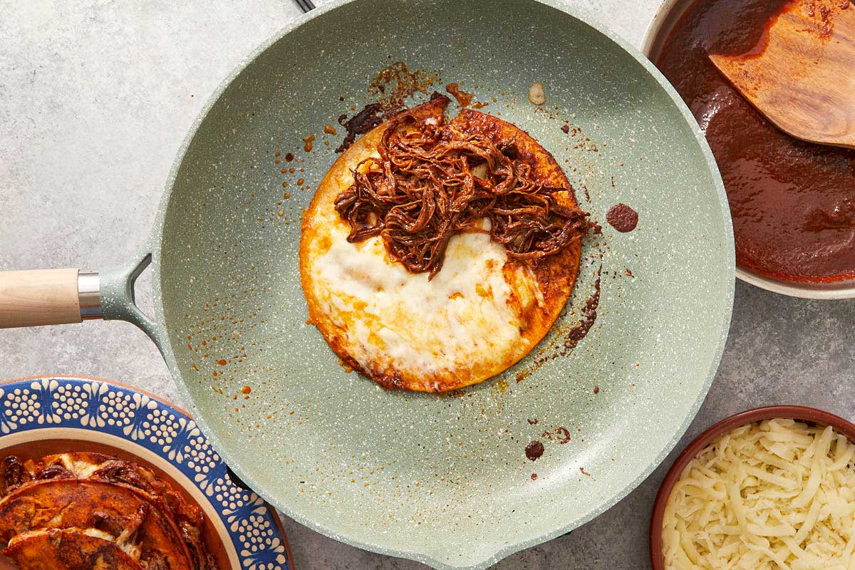 Tortilla filled with cheese and birria meat.