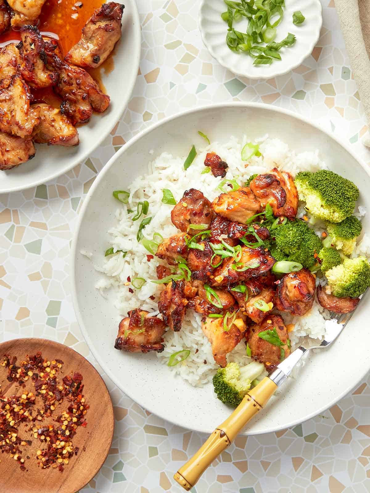 Crispy air fryer teriyaki chicken served over fluffy white rice with steamed broccoli and sliced green onions.
