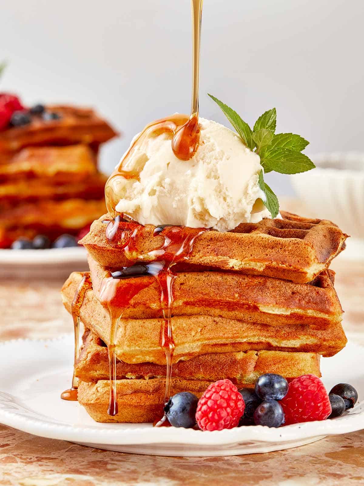  A stack of golden Wancakes with syrup cascading over them, showcasing a delightful breakfast option.