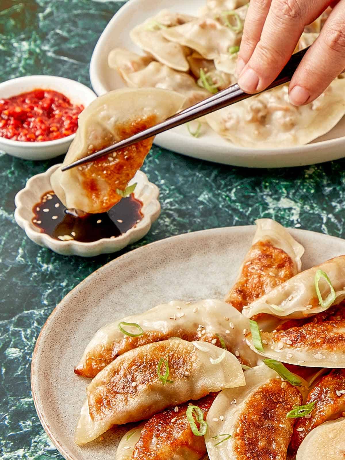 Close-Up of Chinese dumplings with dipping sauce.