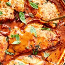 Creamy Marry Me Chicken simmering in a skillet, garnished with fresh basil and ready to serve.
