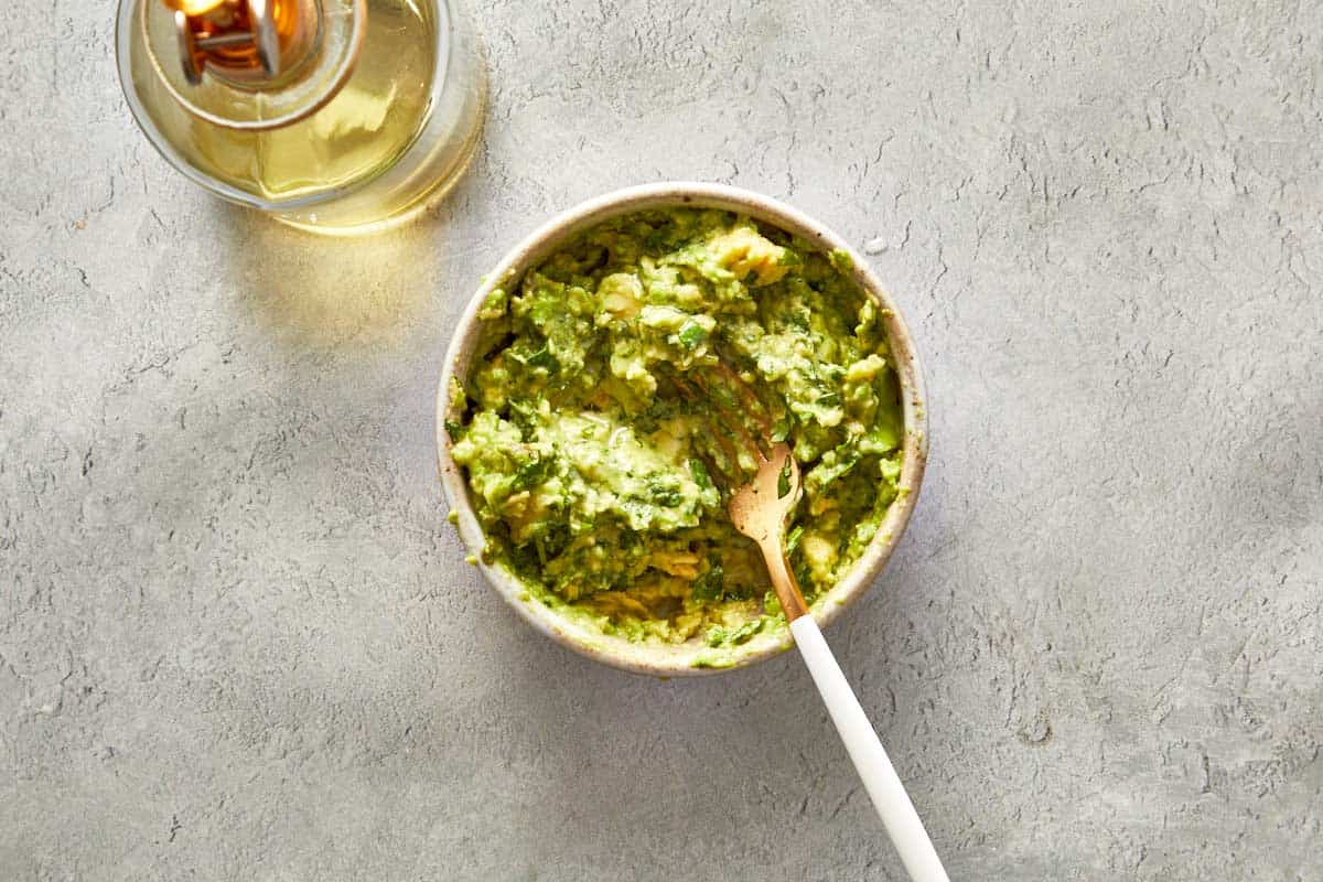 Bowl of fresh guacamole with a spoon