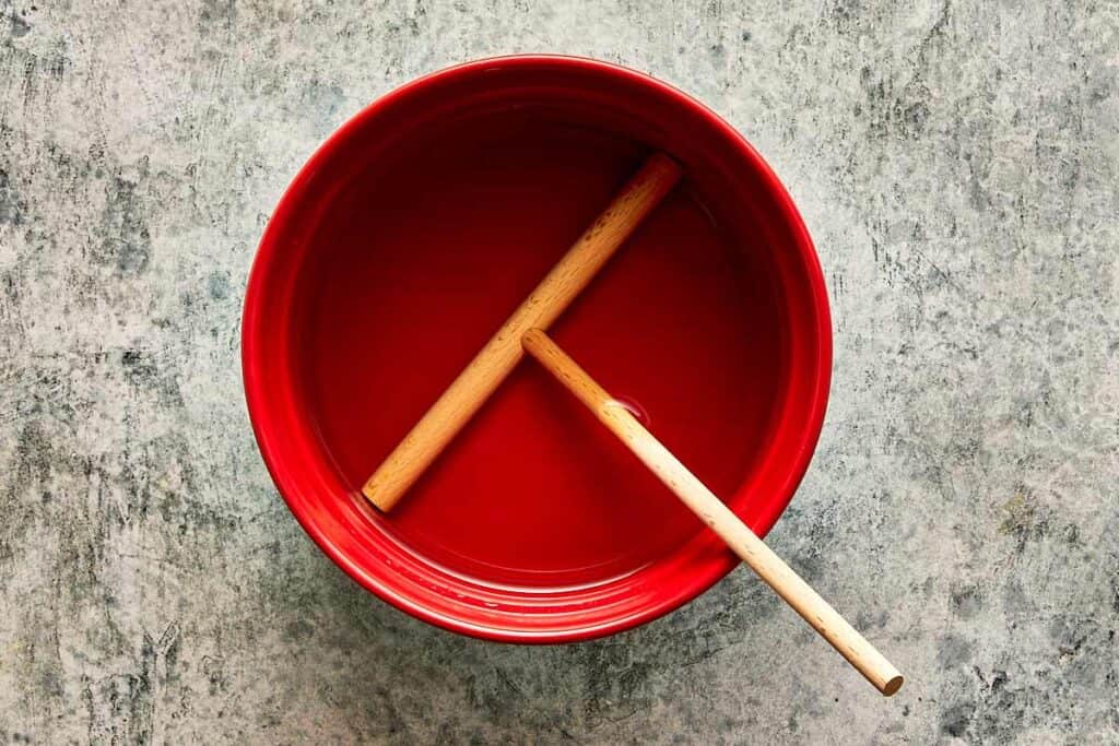a top down view of a pan with a crepe making tool sitting in the middle