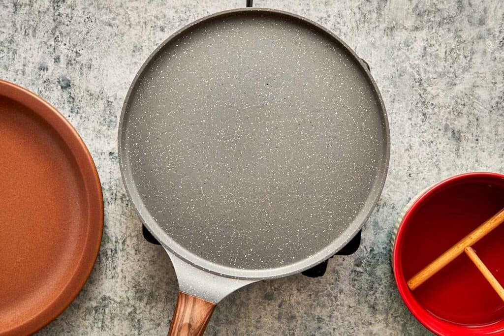 a top down view of a kitchen bench and a crepe pan sitting on top