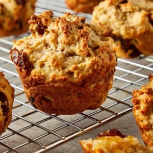 a side view of a muffin on a wire rack cooling