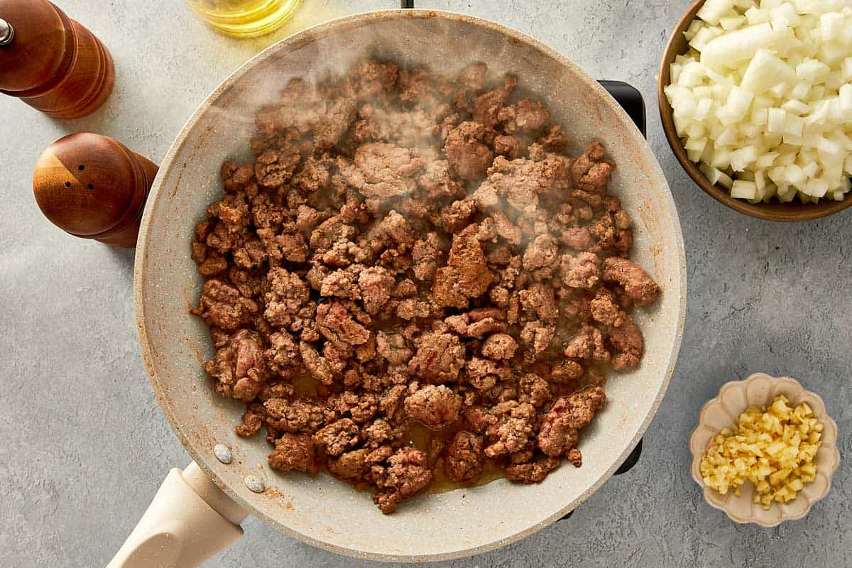 top overview of cooked beef in a beige pan