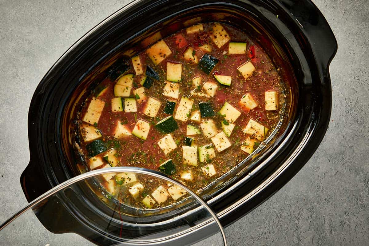 top overview of lasagna soup being covered and cooked in the slowcooker.