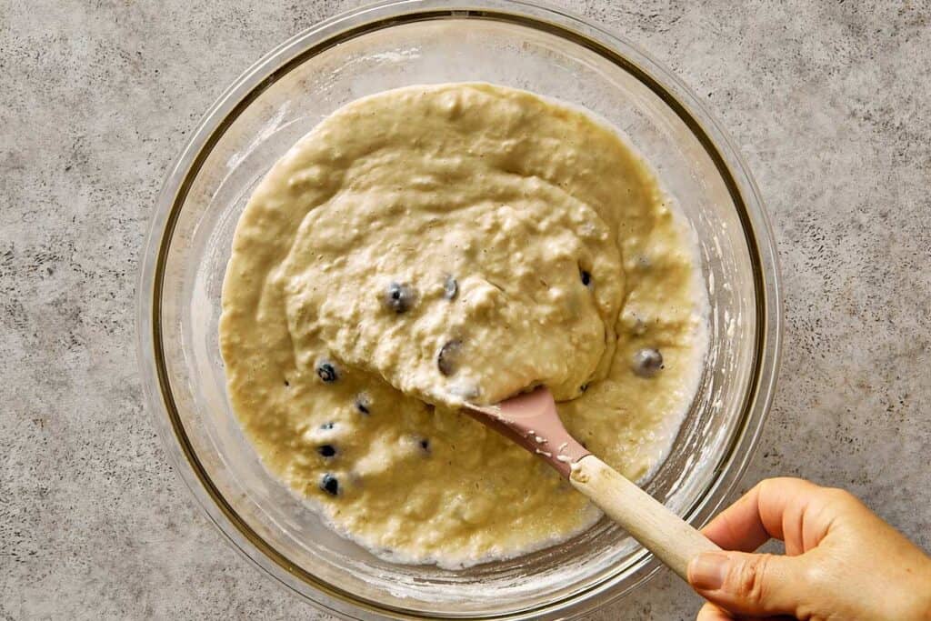 Thick blueberry chocolate chip pancake batter after folding, showing a creamy texture with visible blueberries and chocolate chips before cooking.