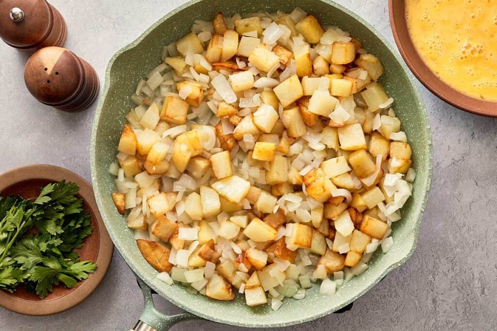 Potatoes and onions cooking together until soft
