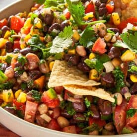 Black eyed pea salad with black beans, corn, tomatoes, peppers and fresh coriander served with tortilla chips.