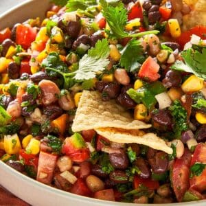 Black eyed pea salad with black beans, corn, tomatoes, peppers and fresh coriander served with tortilla chips.