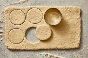 Dough being cut with a pastry cutter | CafeDelites.com