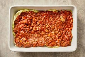 Meat sauce layered over mozzarella cheese in cabbage lasagna.