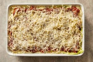 Mozzarella and parmesan cheese added on top before baking cabbage lasagna.