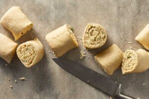 Sliced garlic roll dough showing cheesy swirls inside each piece