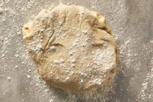 garlic roll dough rolled out on a floured surface before adding filling
