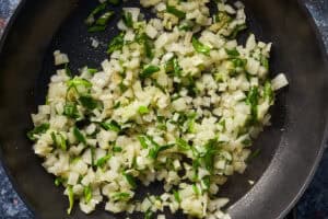 aromatics being cooked in a pan