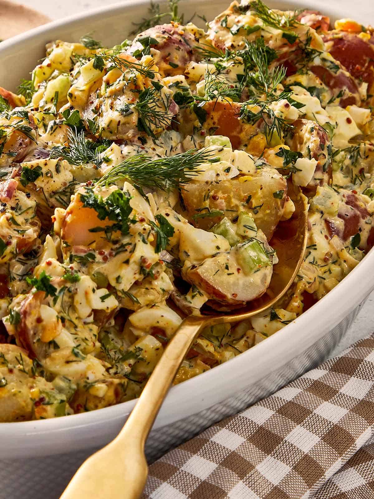 Potato salad being served with a spoon