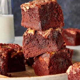 Close up of a view of three pieces of Red Velvet Brownies stacked in a elegant background