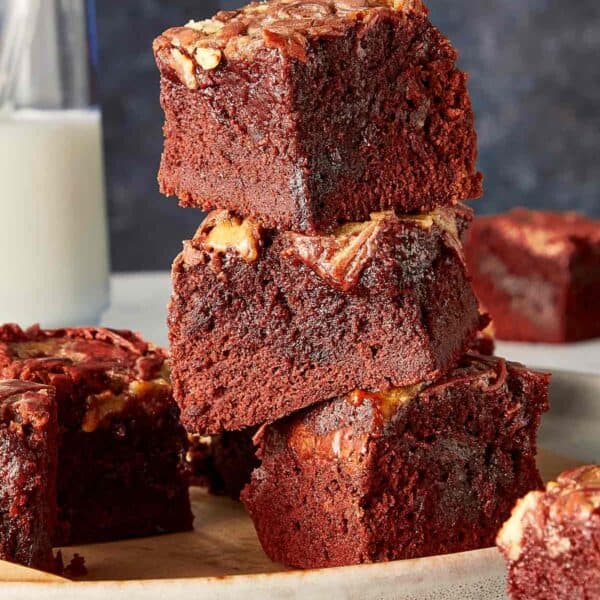 Close up of a view of three pieces of Red Velvet Brownies stacked in a elegant background