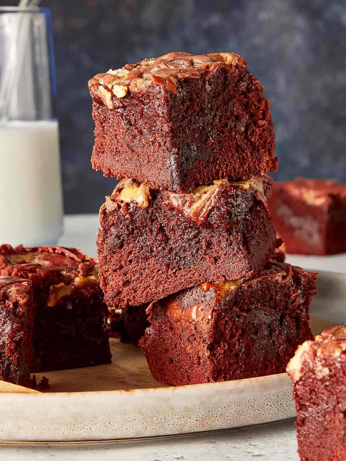 Close up of a view of  three pieces of Red Velvet Brownies stacked in a elegant background 