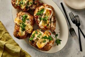 Loaded baked potatoes in a plate ready to eat