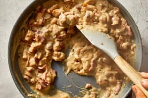 Chicken being mixed for loaded baked potatoes