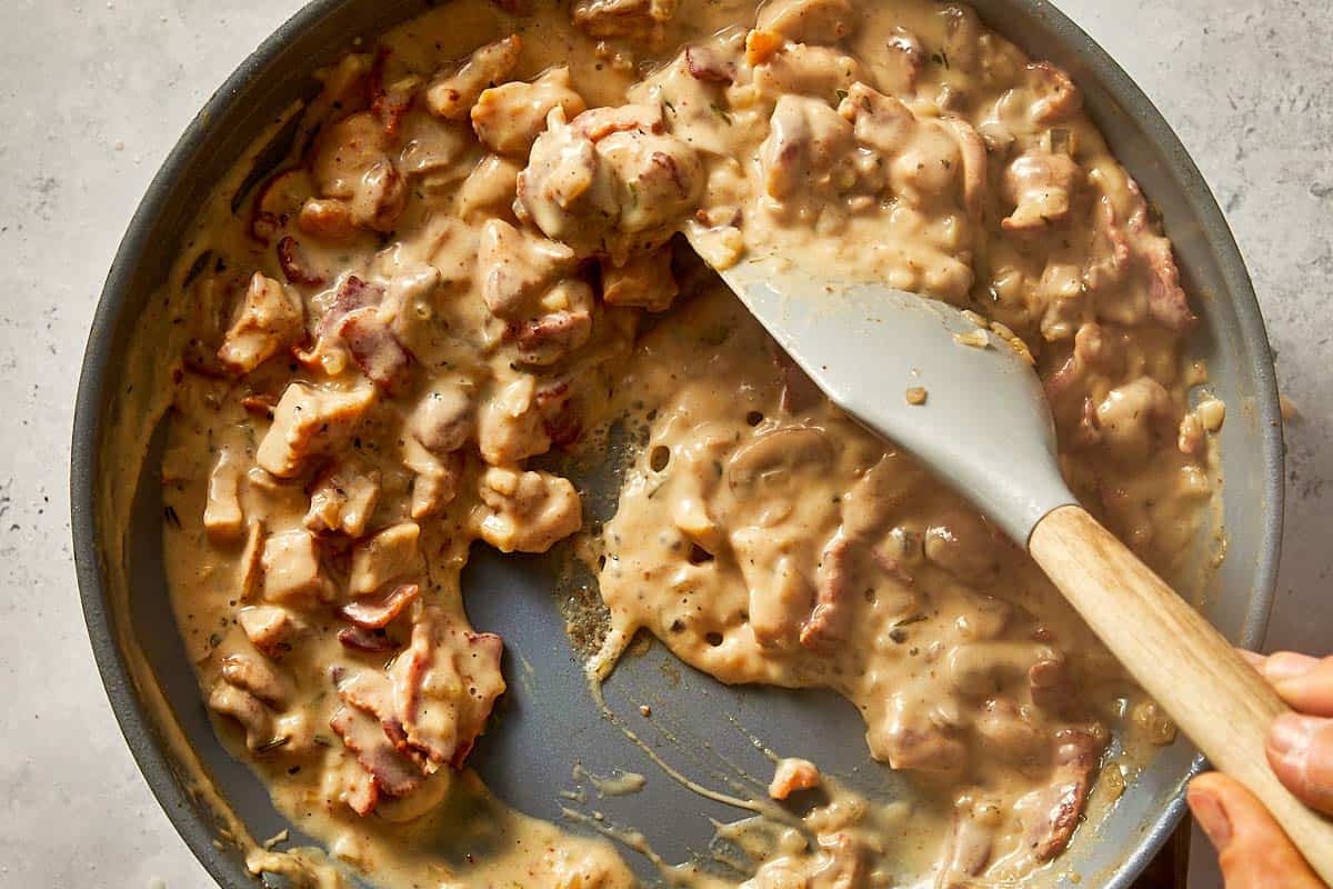 Chicken being mixed for loaded baked potatoes
