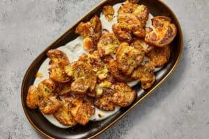 crispy potatoes on top of the whipped feta