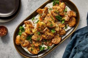 finished smashed potatoes with lemon and whipped cream topped with fresh parsley