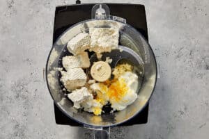 feta, Greek yogurt, grated garlic, lemon juice, and olive oil in a food processor