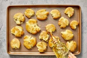 drizzling olive oil to the potatoes