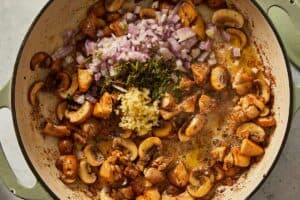 Aromatics being added to the pan
