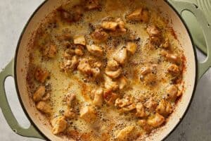 Chicken added to the butter in a large pan