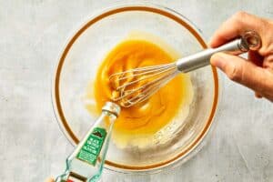Mixing the first stage of the emulsion. Truffle oil and eggs