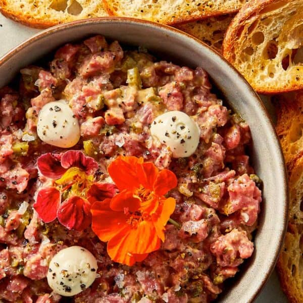 Steak tartare in a bowl with toast at the side ready to be eaten