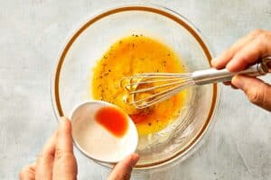 Adding the mix of tabasco and Grand Marnier to the emulsion