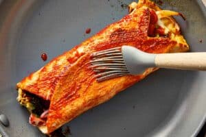 brushing the chicken wrap with the shawarma glaze